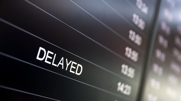 Boarding time monitor screens - timetable boards. Arrivals and departures monitors to check the status of a flight on the airport. Delayed sign.