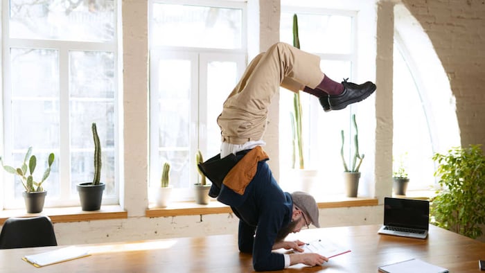 person stretching while working on desk