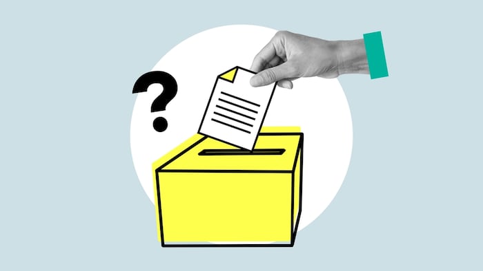 Hand putting a note into a suggestion box