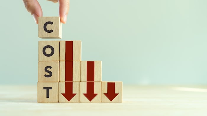 Wooden Blocks Spelling Cost With Arrows Pointing Down