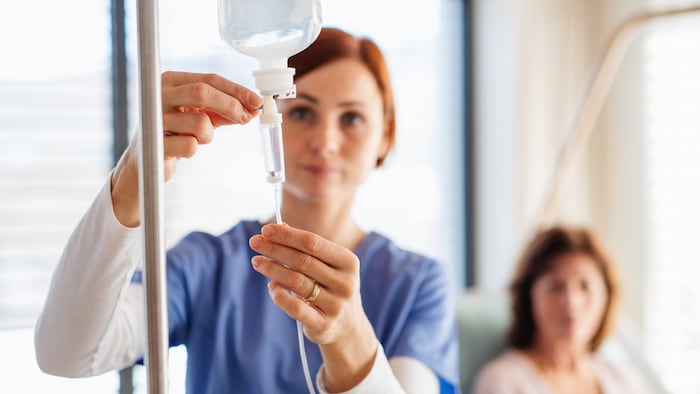 Healthcare professional with infusion bag